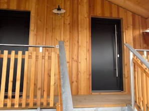 A wooden interior with a staircase, a door, and a light fixture. - "Holz und Himmel" Vacation Rental for 2 People with Open-Concept Living Room and Bedroom, 53 m² (Aschau im Chiemgau)