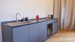 A modern kitchen with a built-in oven, a sink, and a coffee maker. - Luxury Boutique Apartment 2 in Palermo City Center with an Amazing View (Palermo)