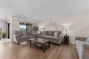 A living room with two sofas, a coffee table, and a lamp. - Treasured Lake Views - 2 Patios (Kimberling City)