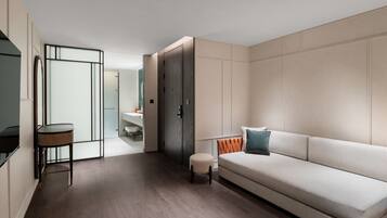 A modern interior with a sofa, a small table, and a cabinet.