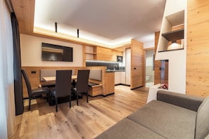 A compact living space with a dining area, kitchenette, and a seating area.
