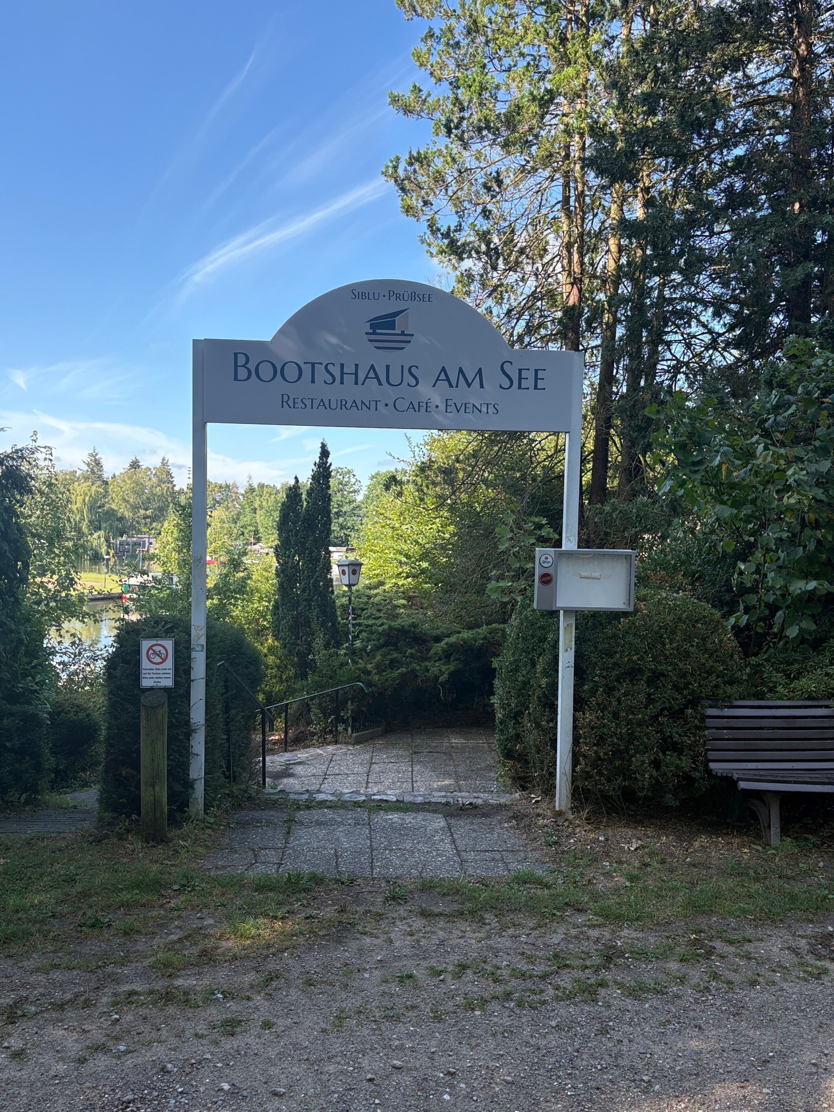 A sign for Bootshaus am See, indicating it is a restaurant, café, and event venue.