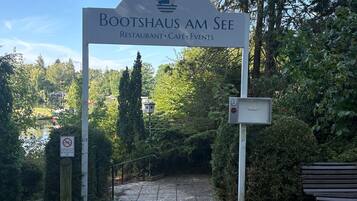 A sign for Bootshaus am See, indicating it is a restaurant, café, and event venue.