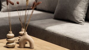 A wooden table with decorative vases and a notebook. - Vida Zisella | Lux Home 7' from Airport (Koropi)
