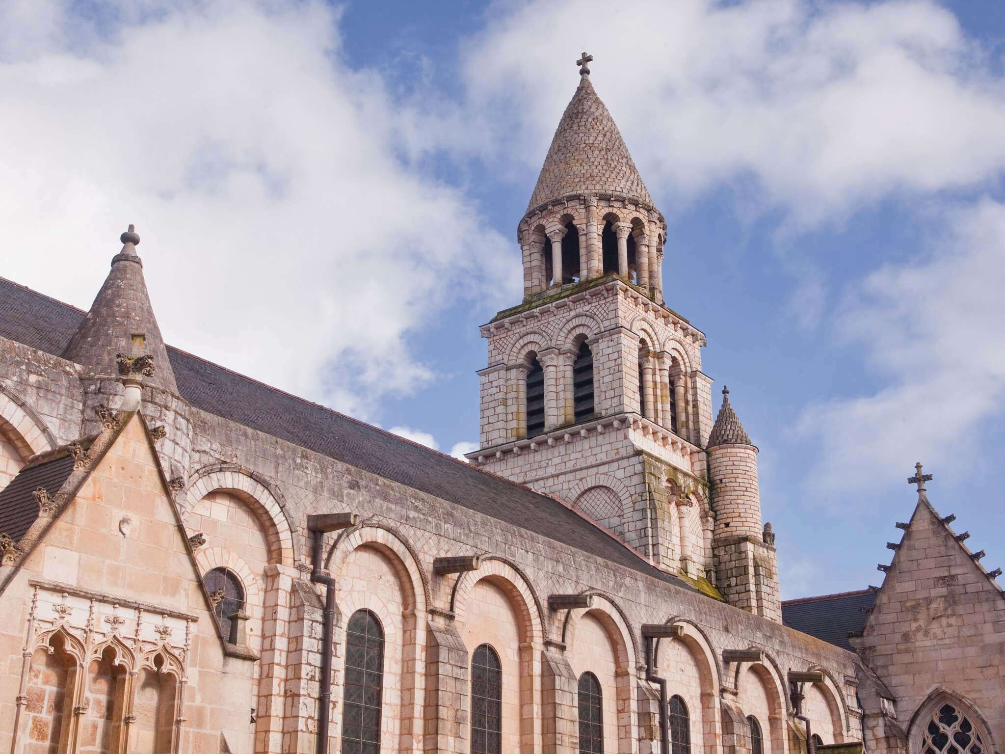 A historic church with a prominent bell tower and arched windows.