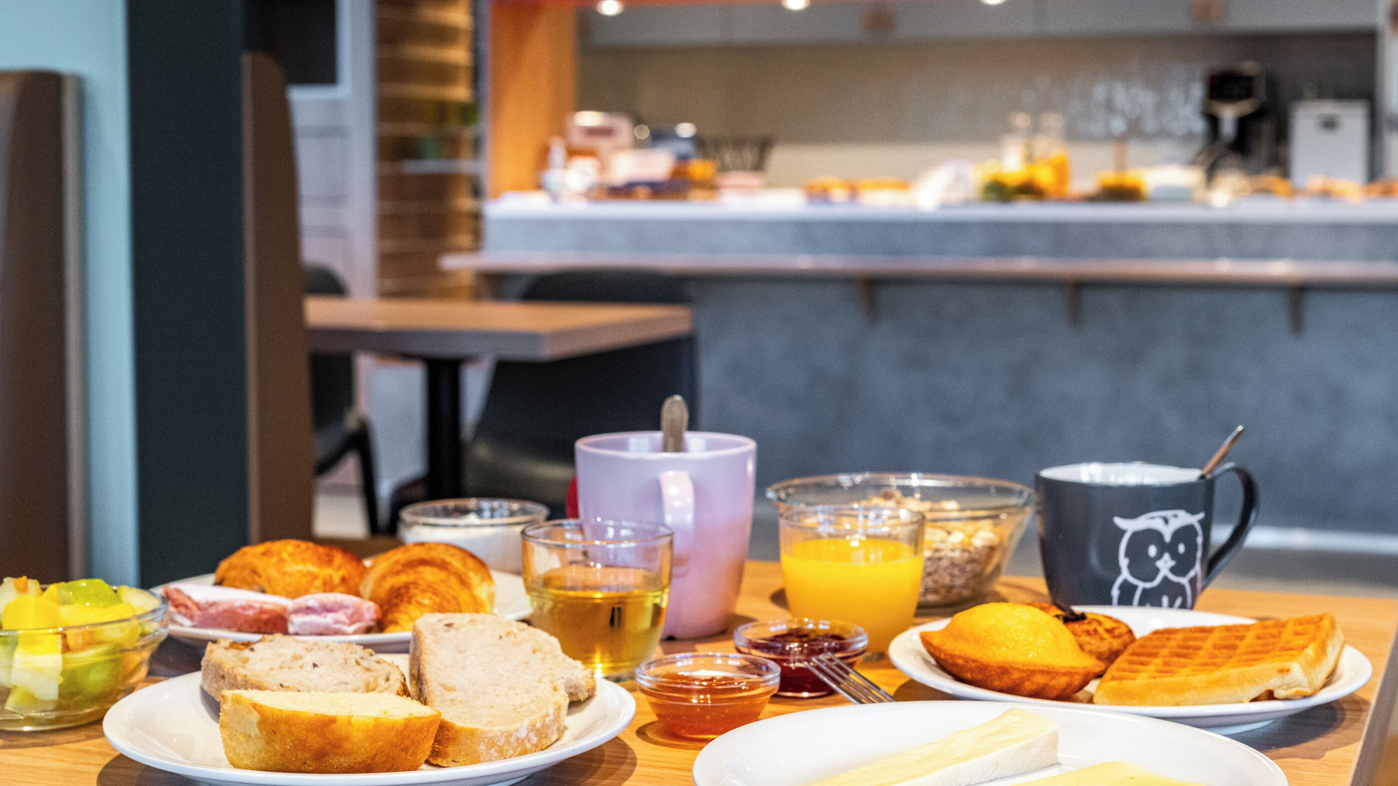 A breakfast buffet with various food items and beverages.