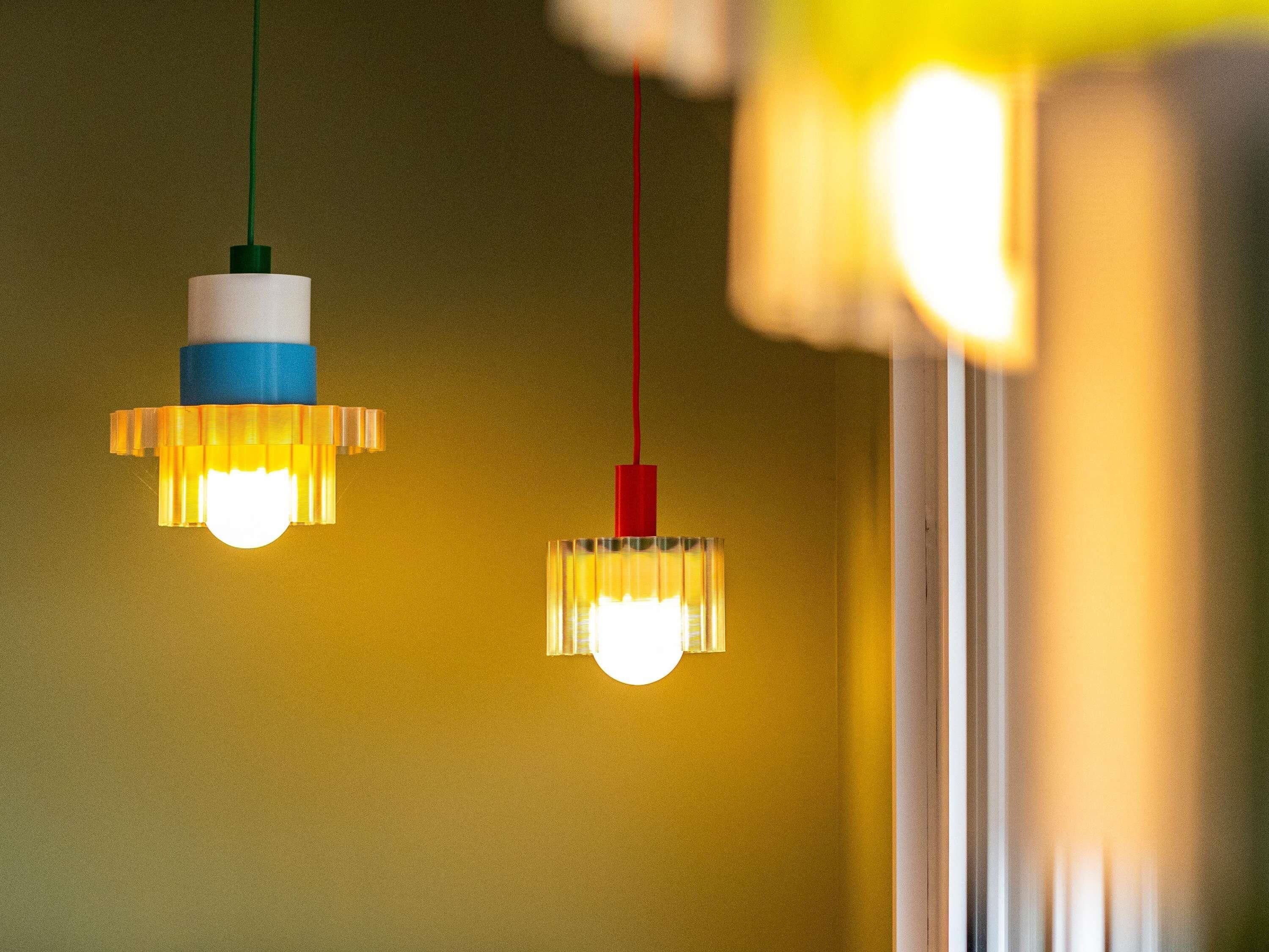 Twee hanglampen met een bijzonder ontwerp aan het plafond.