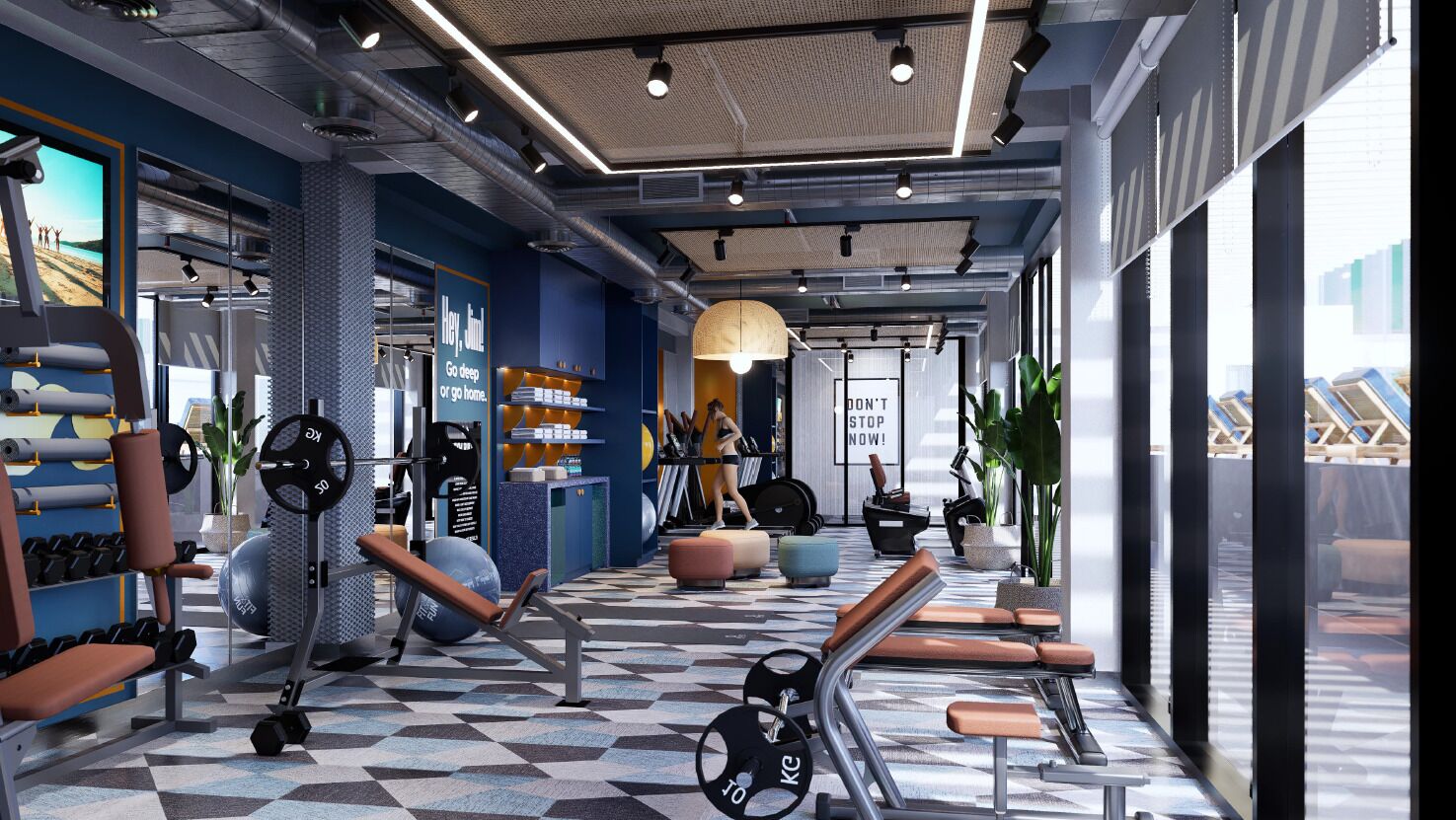 Une salle de sport moderne équipée de matériel d’exercice, dotée d’un comptoir d’accueil et affichant un message motivant.