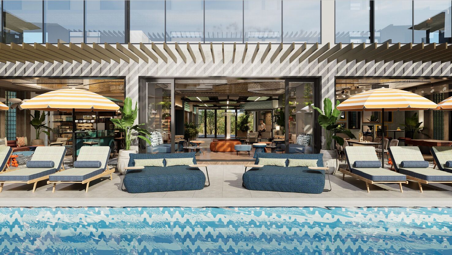 A modern hotel lobby with a pool area, lounge chairs, and striped umbrellas.