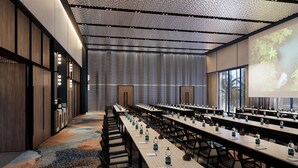 A conference room with long tables, chairs, and a projector screen. - Tribe Na Tomba (Nadi)