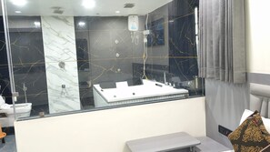 A bathroom with a large mirror, a sink, and a toilet.