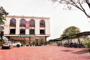 A building with a sign for Mandu's Green Valley Resort and Run by the Phoenix Hospitality. - Mandu's Green Valley Resort (Mandav)