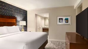 A hotel room with a large bed, a desk, a lamp, a framed picture, and a TV. - Easy Access To Downtown + Free Parking&Restaurant (Pittsburgh)