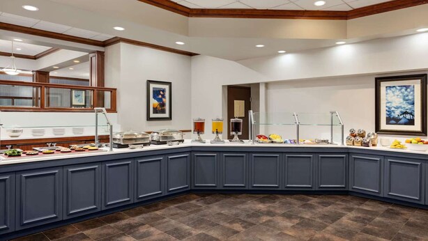 A breakfast buffet with various food items and beverages, a wooden ceiling, and framed artwork on the walls. - Easy Access To Downtown + Free Parking&Restaurant (Pittsburgh)