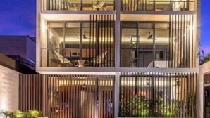 A multi-story building with a modern design, featuring balconies and large windows. - Ocean Boutique Condos (Playa del Carmen)