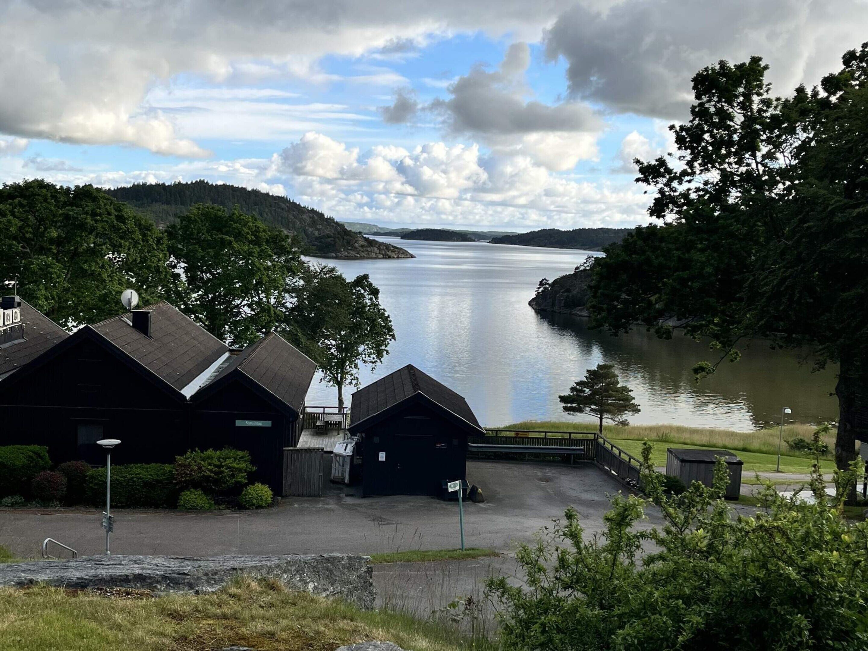 A lakeside property with cabins, a dock, and a view of the lake.