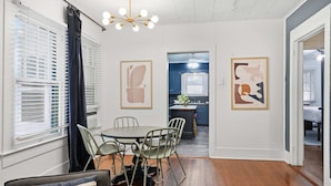 A dining area with a round table, chairs, and a ceiling light fixture. - Private Bedroom in Spacious Home Near Downtown Laf (Lafayette)