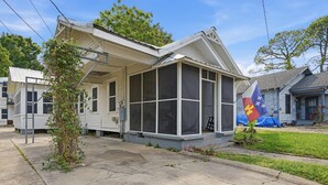 A single-story house with a porch, a flag, and a small tree in front. - Private Bedroom in 4BR Home (Lafayette)
