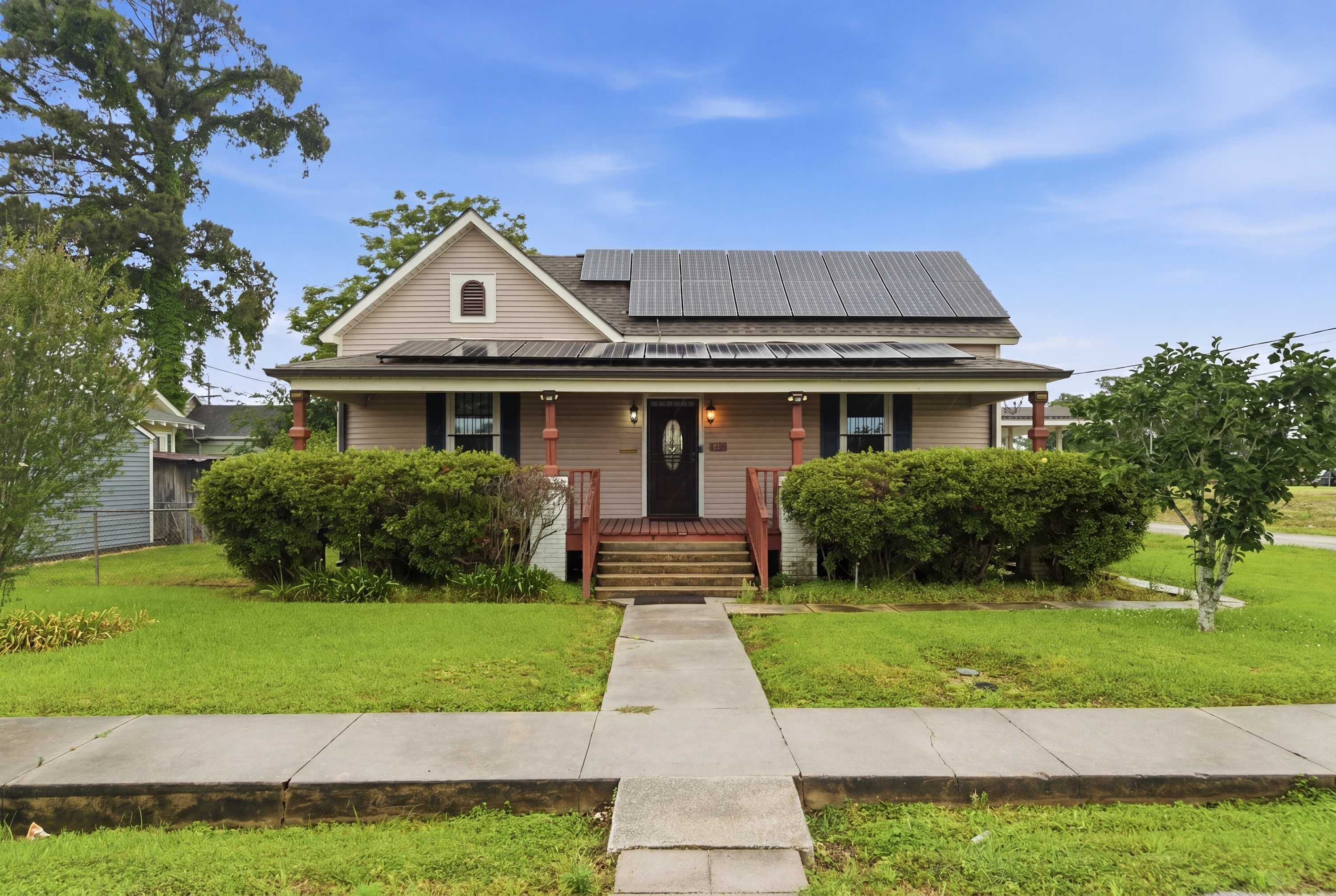 A two-story house with a front porch, a small window, and a door.
