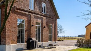 A brick building with large windows, a fire pit, and outdoor seating. - Renovated farmhouse with views over Lillebælt (Sønder Stenderup)