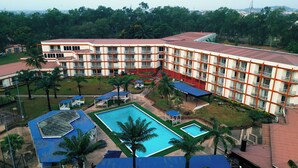 A hotel with multiple floors, a swimming pool, and a landscaped garden. - Landmark Nike Lake Resort (Enugu)