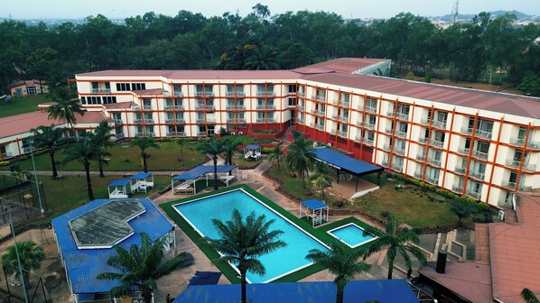 A hotel with multiple floors, a swimming pool, and a landscaped garden. - Landmark Nike Lake Resort (Enugu)