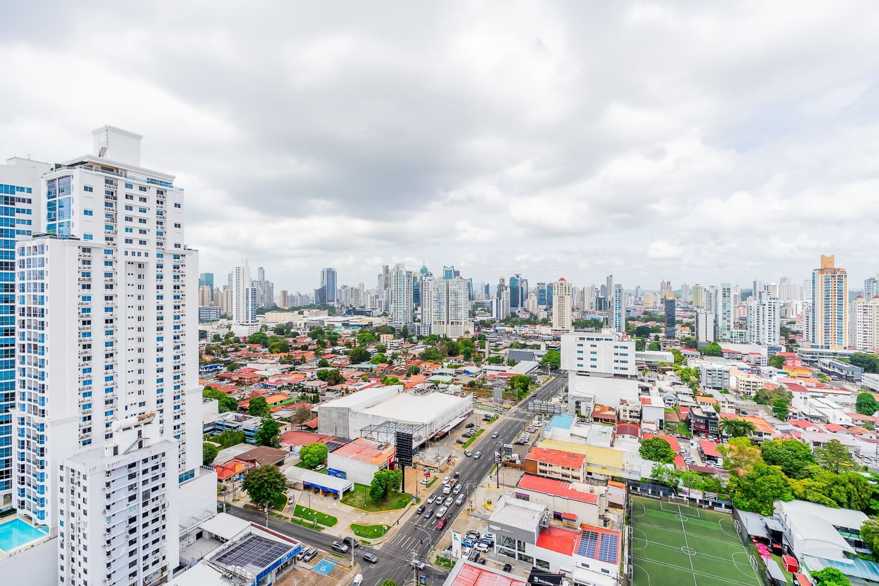 A cityscape with high-rise buildings, a mix of residential and commercial structures, and a clear sky.