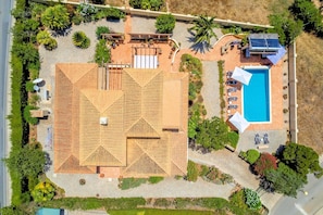 An aerial view of a property with a swimming pool, outdoor seating, and a covered patio area. - Casa Serrao | Carvoeiro | Private Pool & Sea Glimpses | Walk to Dining & Beaches (Carvoeiro)