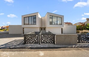 A modern two-story building with large windows, a gated entrance, and a flat roof. - Pet friendly home in Vodice (Vodice)