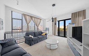 A modern living room with a sofa, a round coffee table, and a TV. - Pet friendly home in Vodice (Vodice)