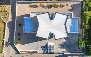 An aerial view of a hotel with a central swimming pool, two smaller pools, and a covered outdoor seating area. - Pet friendly home in Vodice (Vodice)