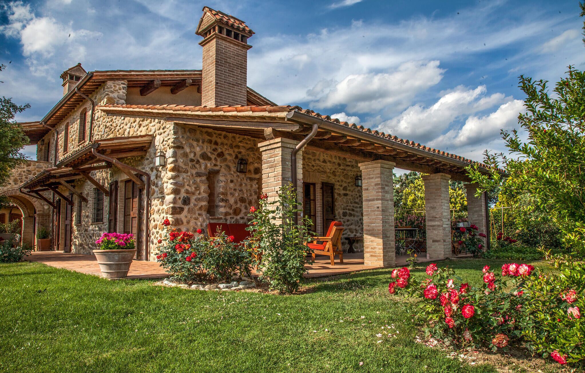 A stone house with a patio and garden.
