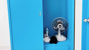 A blue wardrobe with a fan and an iron inside. - Room-105 Budget Room, Wifi&utilities Ban (Bangkok)