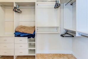 A walk-in closet with open shelves, hanging space, and a bed with a blanket. - 5 Mi to Estrella Mtn Park! Home w/ Outdoor Oasis (Goodyear)