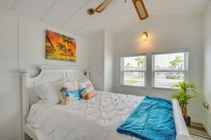 A bedroom with a bed, pillows, a painting, a window with blinds, and a plant. - 5 Mi to Fort Myers Beach! Home w/ Resort Perks (Fort Myers)