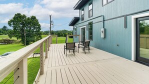 A deck with outdoor seating, a railing, and a view of a green landscape. - Close to Ohio River: 6BR Jeffersonville Home (Jeffersonville)