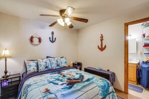 A bedroom with a bed, a ceiling fan, and nautical-themed decor. - Lake-view Deck! Lake of the Ozarks Home in Edwards (Edwards)