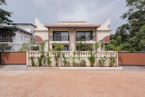 A two-story building with a traditional architectural style, featuring a balcony on the second floor and a gated entrance. - Staymaster Abira-3BR Pvt Pool Villa (Assagao)