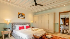 A bedroom with a bed, bedside tables, a ceiling fan, a wardrobe, and a patterned rug. - Staymaster Abira-3BR Pvt Pool Villa (Assagao)