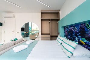 A modern hotel room with a bed, a seating area, a wardrobe, and a large mirror. - Studio in Las Palmas Near Playa de Las Canteras (Las Palmas de Gran Canaria)