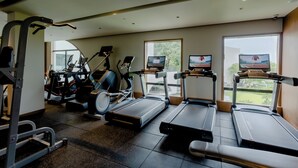 A gym with treadmills, elliptical machines, and weight equipment.