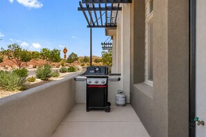 A barbecue grill on a balcony with a view of a desert landscape. - Splash and Swing: Desert Color Lagoon + Beaches (St. George)
