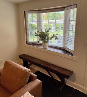 A room with a window, a bench, and a chair. - Executive Sloan’s Lake Charmer (Denver)