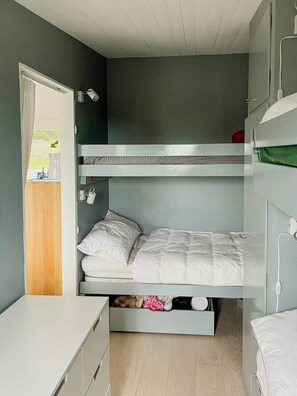 A bunk bed room with a desk and a window. - Architect-designed cottage where sea meets forest (Haverdal)