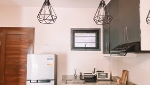 A compact kitchen with a refrigerator, a microwave, a toaster, and a stove. - 1BR Apartment Beach Getaway Perfect for Couples (San Fernando)