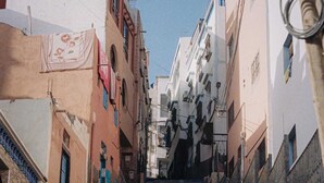 A narrow street with a steep staircase leading up to a building.