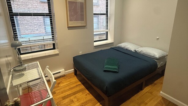 A bedroom with a bed, a desk, and two windows. - Discover the Comfort of Columbia University Area-2 (New York)
