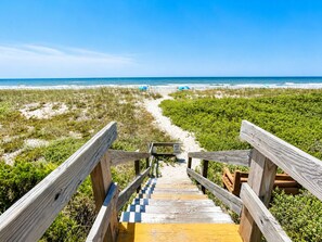 A wooden boardwalk leading to a beach with a clear view of the ocean. - Dunescape Villas 108 (Atlantic Beach)