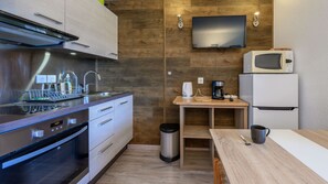 A compact kitchen with a microwave, coffee maker, and a sink. - Cabin apartment with mountain view (Morillon)