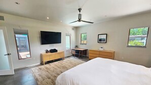 A modern bedroom with a large bed, a desk, a chair, a TV, and a ceiling fan. - Private Luxury Modern Design with NM charm: Gourmet Kitchen & Spa Bath! (Taos)